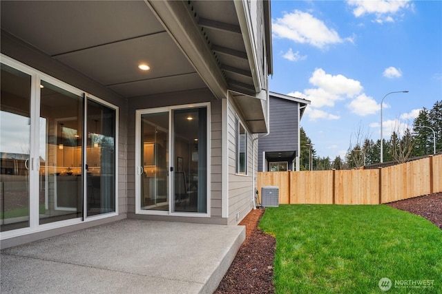 view of yard featuring a patio, cooling unit, and fence