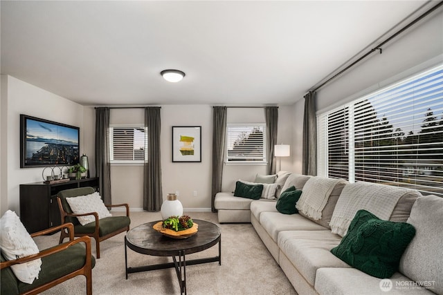 living room featuring light colored carpet and baseboards