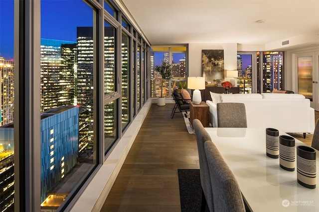 wine area with dark hardwood / wood-style floors and expansive windows