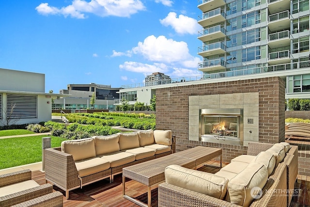 view of patio / terrace with an outdoor living space with a fireplace