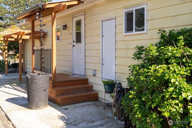 view of exterior entry featuring a patio area