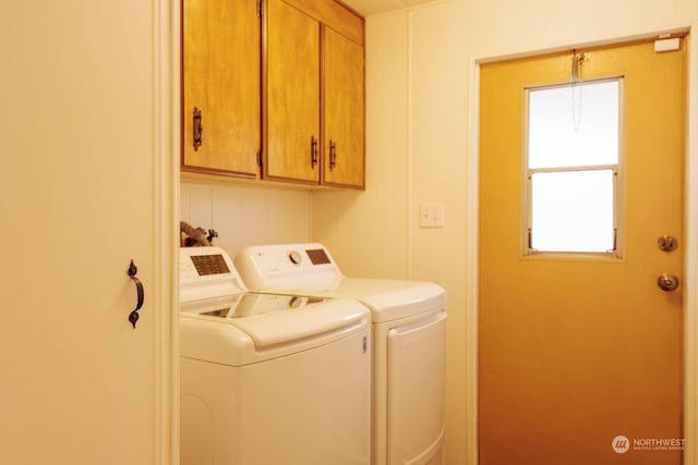 laundry room with cabinets and washing machine and clothes dryer