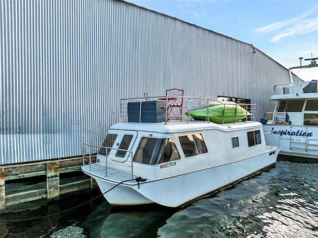 view of dock with central air condition unit and a water view