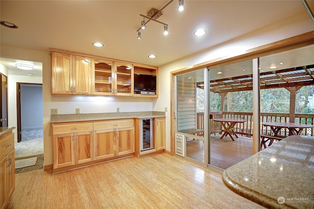 kitchen with wine cooler and light wood-type flooring