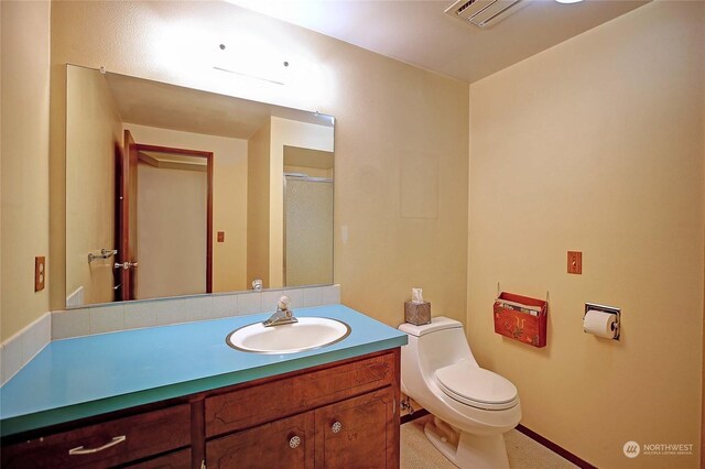 bathroom featuring toilet and vanity