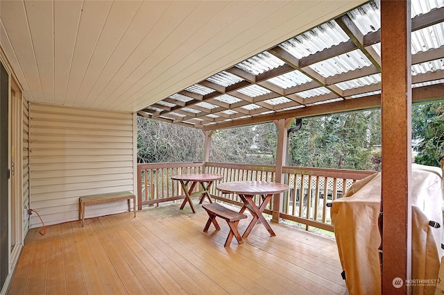 wooden terrace featuring a pergola and a grill