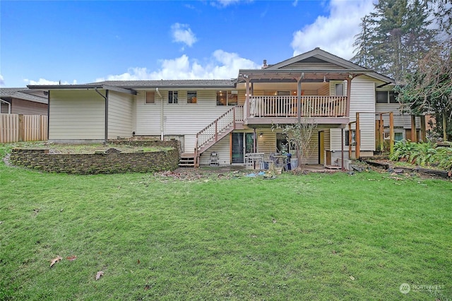 rear view of house with a wooden deck and a yard