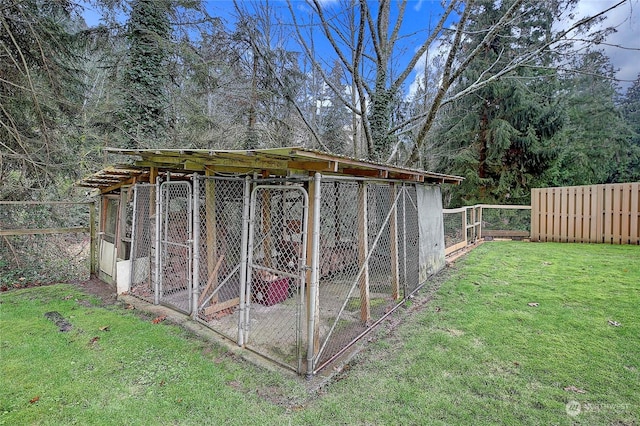 view of outbuilding featuring a lawn