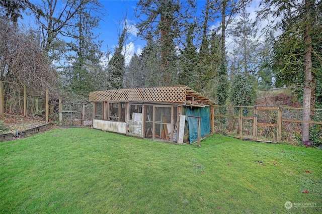 view of outdoor structure featuring a lawn