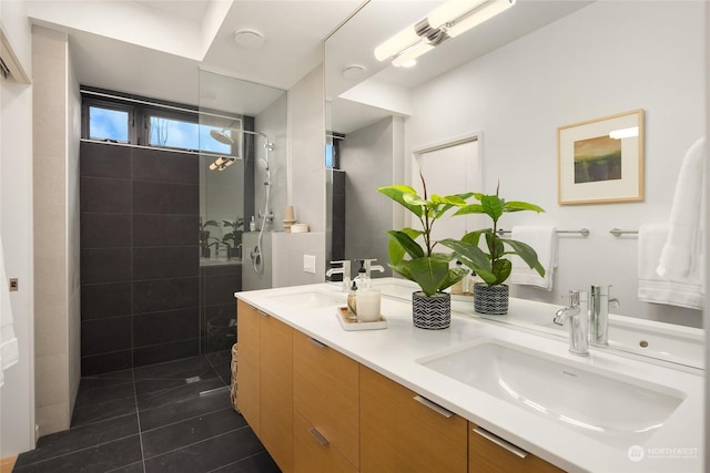 bathroom with vanity, tile patterned floors, separate washer and dryer, and a tile shower