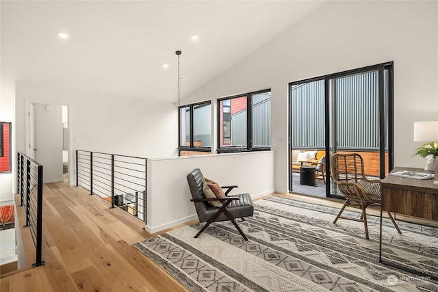 sitting room with lofted ceiling and light hardwood / wood-style flooring