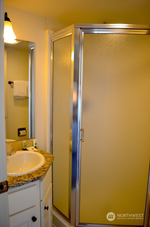 bathroom featuring vanity and walk in shower