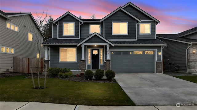 craftsman-style house featuring a garage and a yard