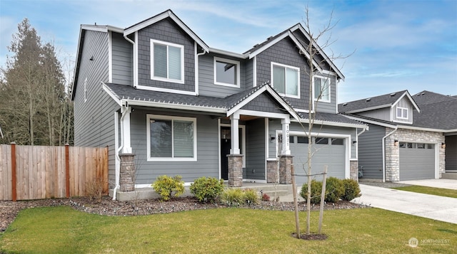 craftsman house with a front lawn, covered porch, and a garage