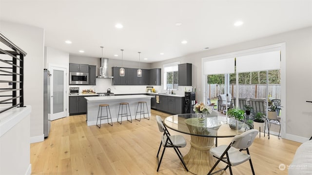 dining room featuring light hardwood / wood-style floors and sink