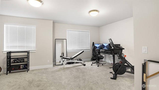 exercise room featuring light carpet