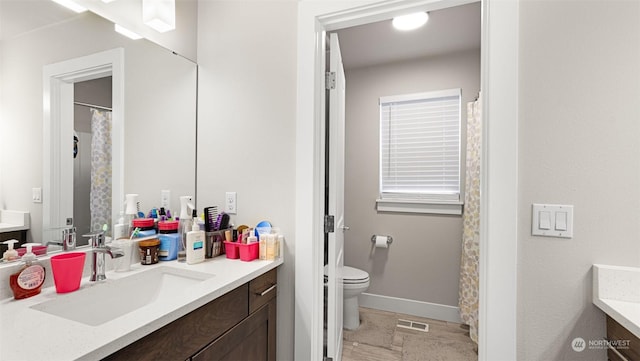 bathroom with toilet and vanity