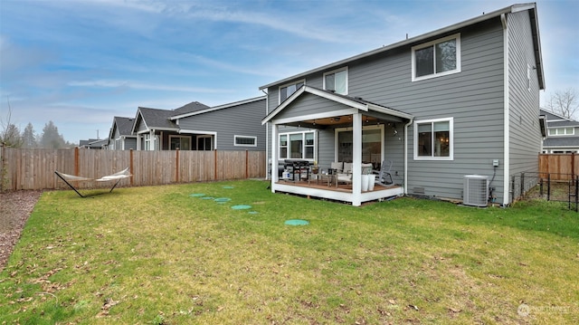 back of house featuring a deck, cooling unit, and a yard