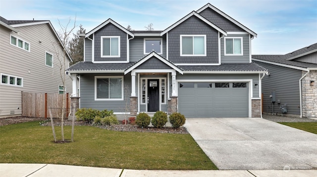 craftsman-style house featuring a front yard and a garage