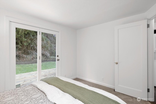 carpeted bedroom featuring access to outside and multiple windows