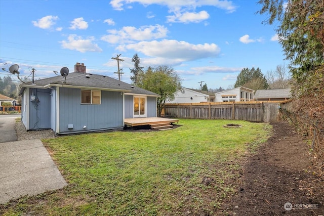 back of house featuring a deck and a yard