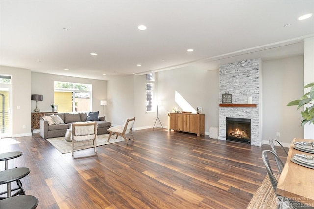 living room featuring dark hardwood / wood-style flooring and a fireplace