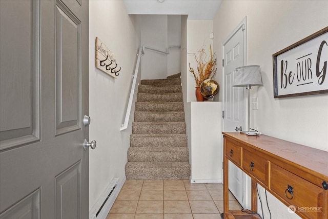 stairs with tile patterned floors and a baseboard radiator