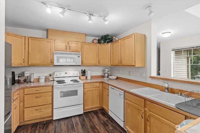 kitchen with sink, white appliances, light brown cabinets, and dark hardwood / wood-style floors