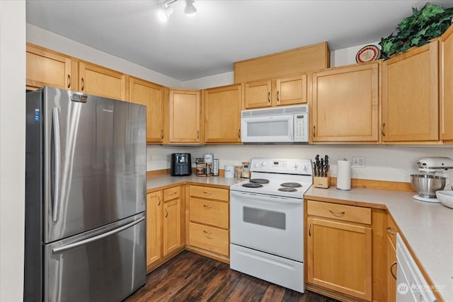 kitchen with light brown cabinetry, dark hardwood / wood-style floors, and white appliances