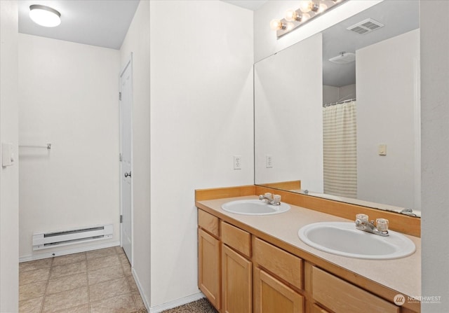 bathroom featuring a baseboard heating unit and vanity