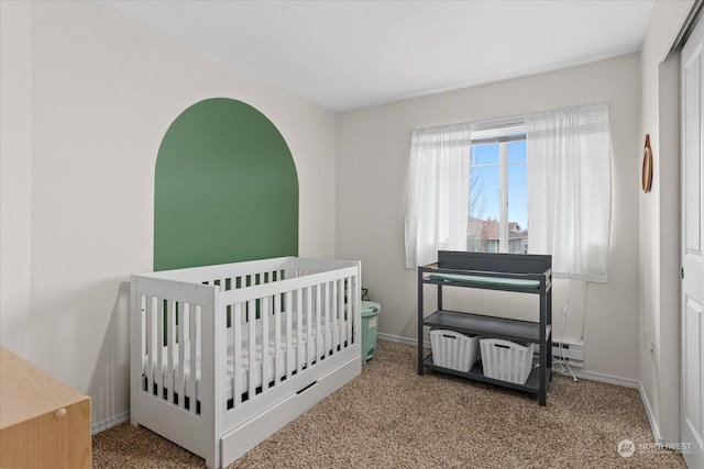 bedroom with carpet floors and a nursery area