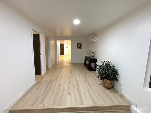 hall featuring light wood-type flooring, an AC wall unit, and ornamental molding