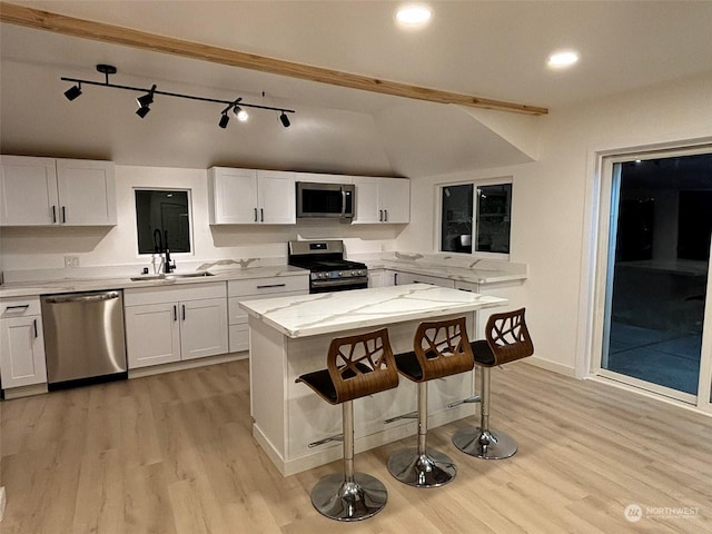 kitchen with sink, white cabinets, and appliances with stainless steel finishes