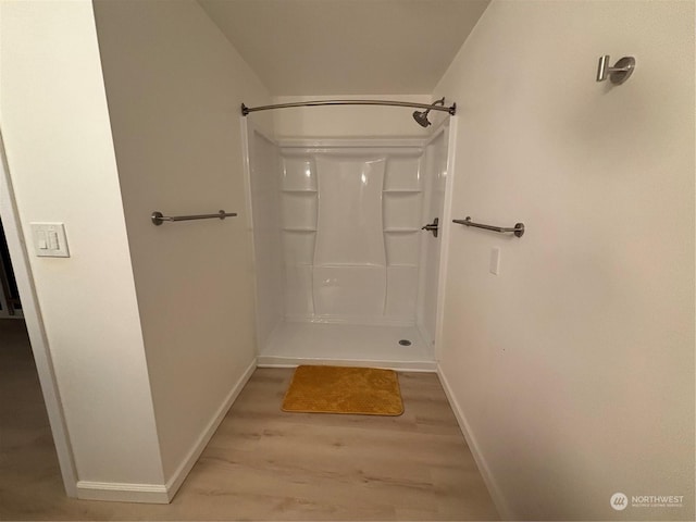 bathroom with wood-type flooring and a shower