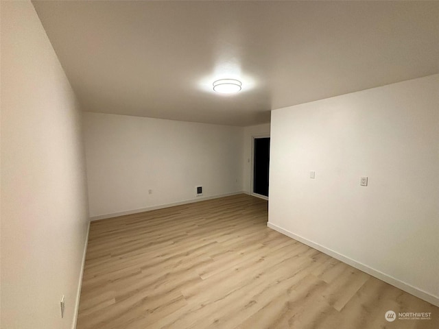 empty room with light hardwood / wood-style floors