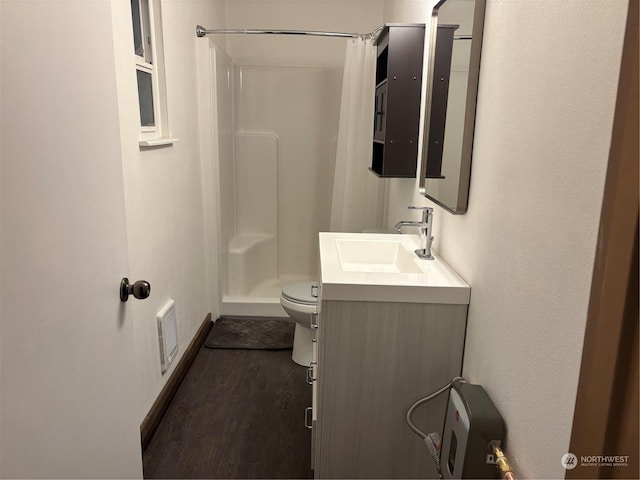 bathroom featuring toilet, a shower with shower curtain, hardwood / wood-style floors, and vanity