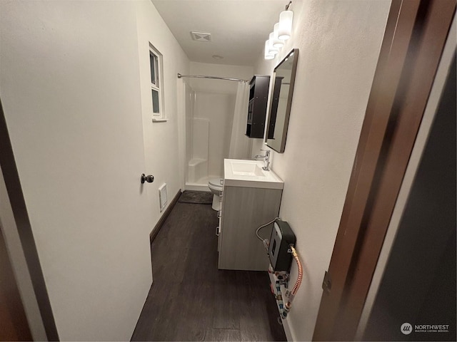 corridor with dark hardwood / wood-style flooring and sink