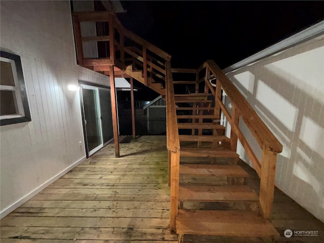 stairs with hardwood / wood-style flooring