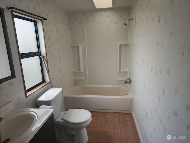 full bathroom with toilet, shower / tub combination, wood-type flooring, and vanity