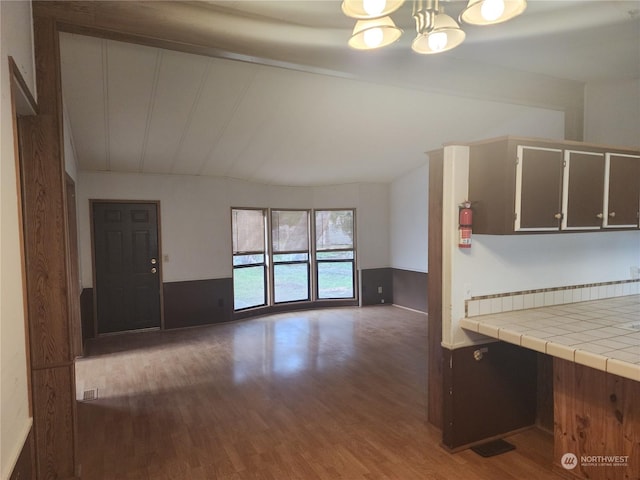 kitchen with tile counters and dark hardwood / wood-style flooring