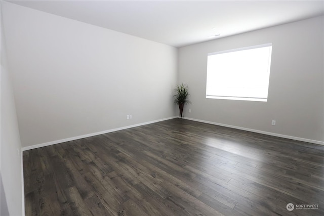 spare room featuring dark hardwood / wood-style floors