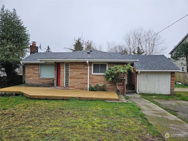 view of front of home with a deck and a front yard