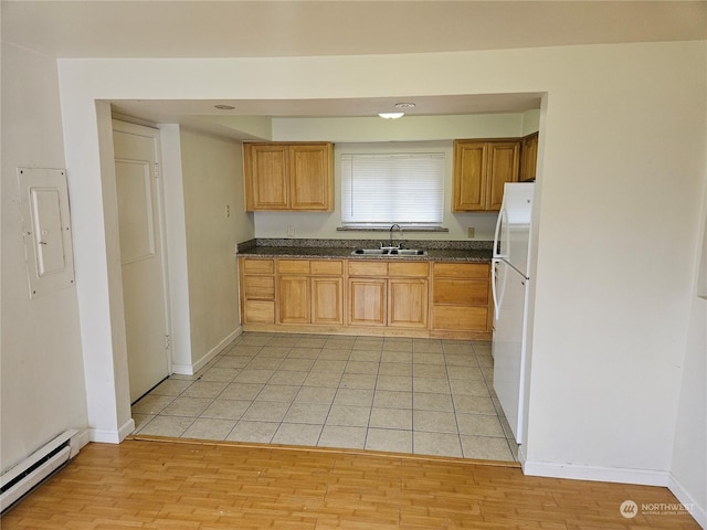 kitchen with a baseboard heating unit, electric panel, sink, light wood-type flooring, and white refrigerator