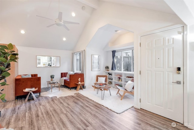 sitting room with light hardwood / wood-style flooring, vaulted ceiling with beams, and ceiling fan