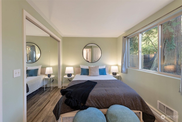 bedroom with hardwood / wood-style floors and a closet