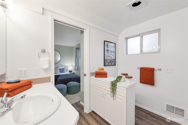 bathroom with vanity and hardwood / wood-style flooring