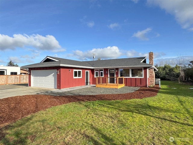 ranch-style house featuring a front yard and a garage