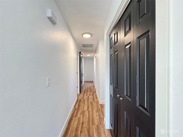 hall with light hardwood / wood-style floors