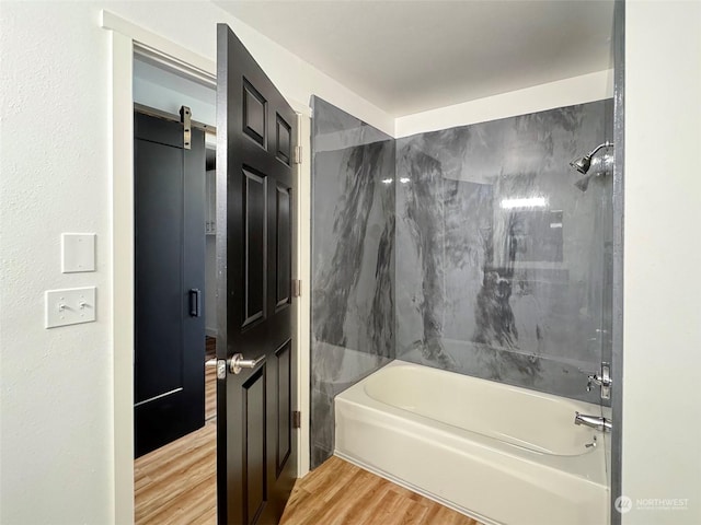 bathroom featuring hardwood / wood-style flooring and bathtub / shower combination