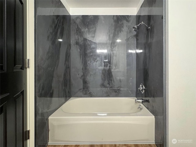 bathroom with shower / bath combination and wood-type flooring